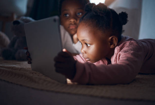 istock Shot of siblings using their digital tablet together 1345114170