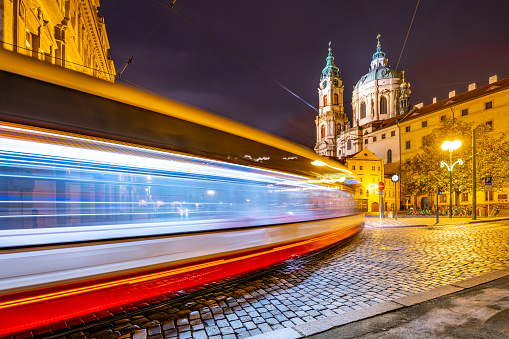 Lesser Town in Prague by night. Evening public transportation. Motion blurred tram. Prague, Czech Republic