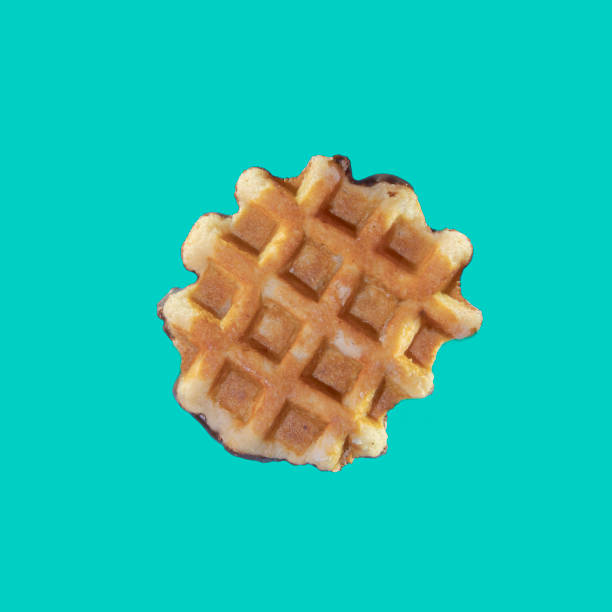istock The texture of a standard waffle, on a light blue background. Square format 1345115982