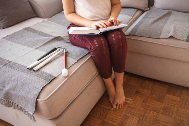 istock Blind person reading book written in Braille. 1345121255