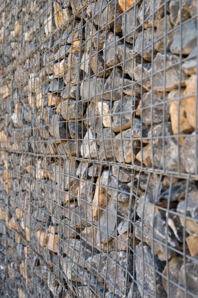 istock stones behind metal fence 1345124654