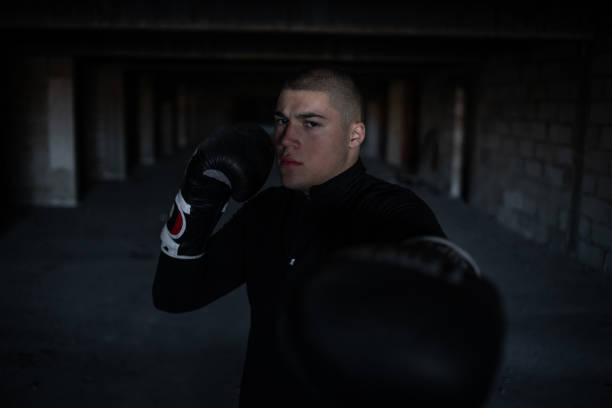 istock A kickboxing man trains alone in an abandoned building 1345124978