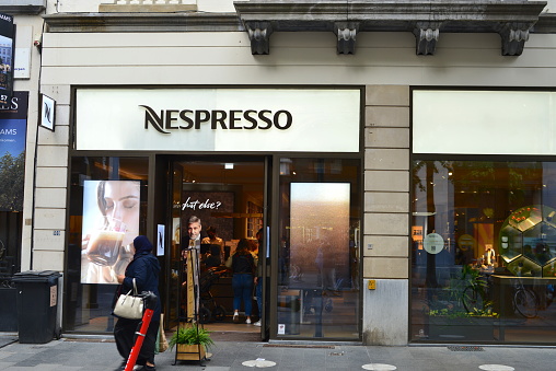 Antwerp Belgium - October 2, 2021: main shopping Leyss street, shoppers along the shops. Coffee shop Nespresso. 