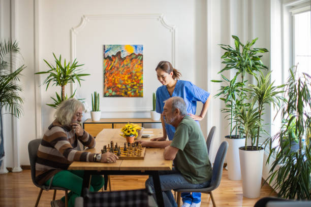 istock Senior men having fun playing chess at nursing home 1345133694