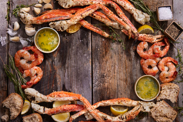 Luxury king kamchatka crab cooked seafood served with lemon and herbs on rustic wooden board premium gourmet copy space.