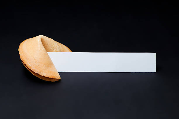 Chinese fortune cookie and blank paper. Chinese Fortune Cookie with copy space on the dark background. herakleion photos stock pictures, royalty-free photos & images