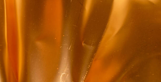 istock crinkled gold foil with visible details. background or texture 1345135636