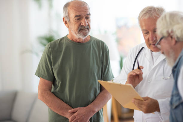 istock Doctor having a conversation with two senior men in nursing home 1345135900