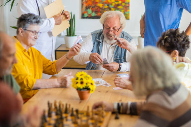 istock Senior people having fun playing cards in retirement home 1345136259