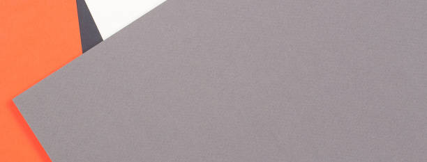 istock Creative abstract geometric colored paper background in orange, light gray, white, black colors 1345137346