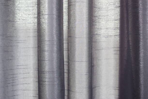 istock Violet curtains close-up with play of light and with partial abstract blur 1345137928