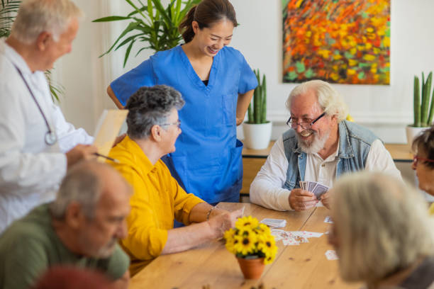 istock Senior people playing cards in retirement home 1345138580