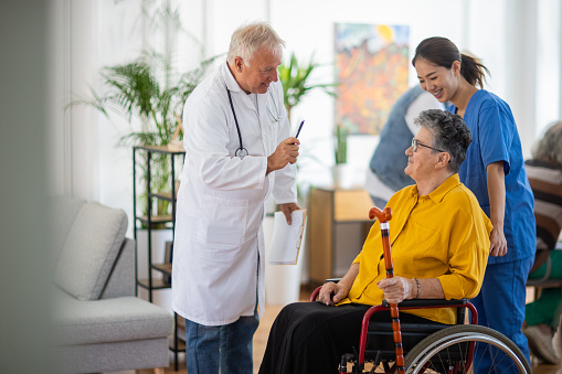 Doctor having a conversation with senior patient in nursing home