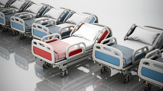 Red hospital bed stands out among other beds in a row.