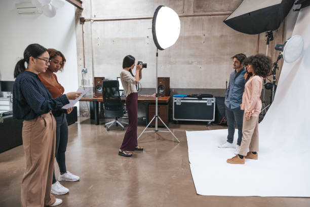istock Photographer and her team working in a fashion studio 1345144638