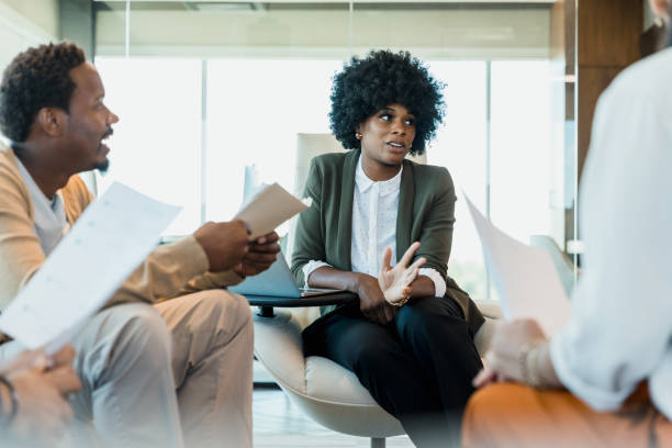 istock In modern office setting, mid adult CEO meets with employees 1345146526