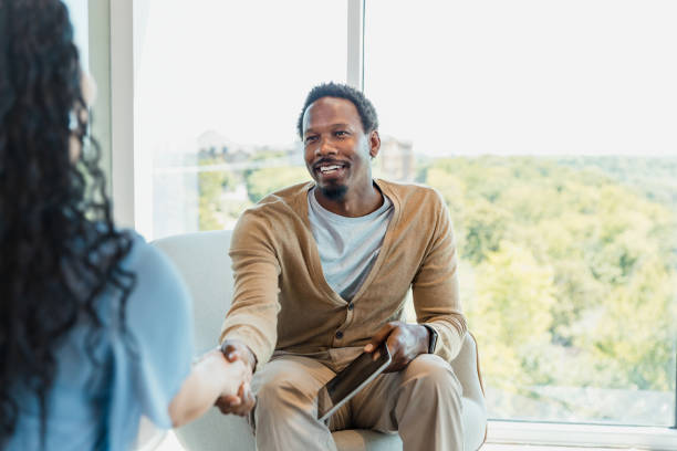 istock Male CEO greets female applicant with smile and handshake 1345146576