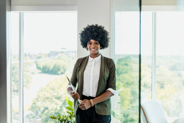 istock Female college student smiles for camera on way to class 1345146609