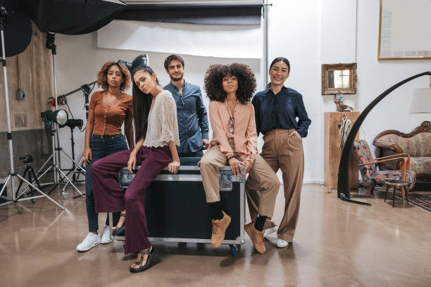 istock Happy Team posing after a shoot in a photo studio 1345146756