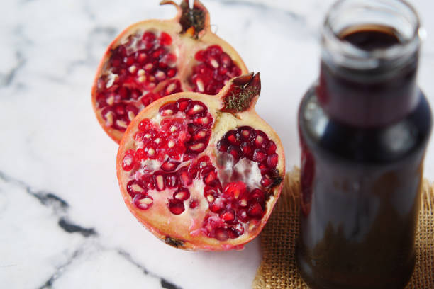 istock glass on pomegranate juice on red background . 1345147241
