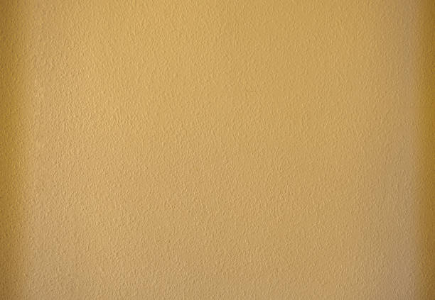 istock Abstract rough wall as background. Yellow color wallpaper. 1345148877