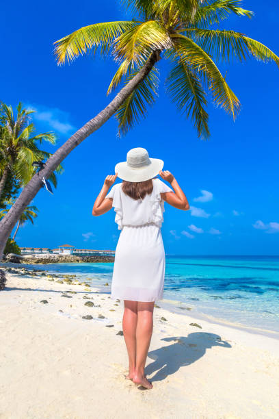 istock Woman standing on the beach 1345149231