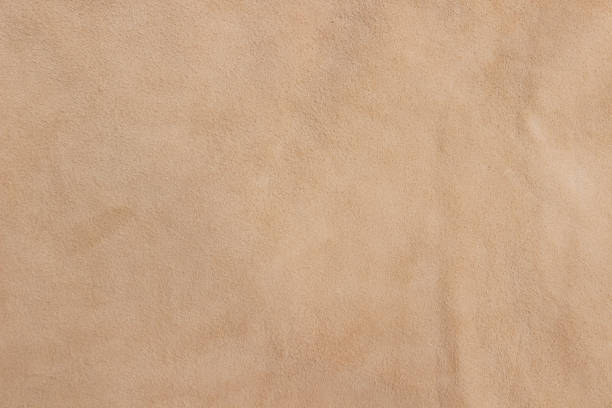 Sample of genuine calfskin of the highest quality. Sample of genuine calfskin of the highest quality. Beige leather texture or background. faux suede stock pictures, royalty-free photos & images