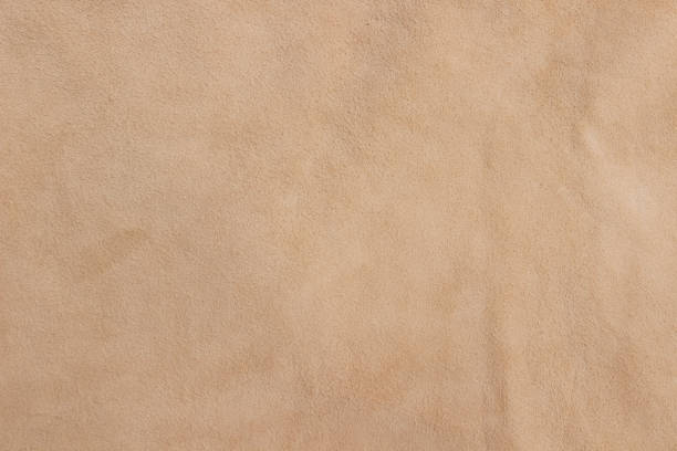 Sample of genuine calfskin of the highest quality. Sample of genuine calfskin of the highest quality. Beige leather texture or background. suede stock pictures, royalty-free photos & images