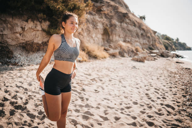 istock A woman exercises and stretches on the beach 1345151662