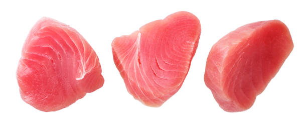 istock Raw tuna fish medallions set on a white background, cut. Isolated 1345151696