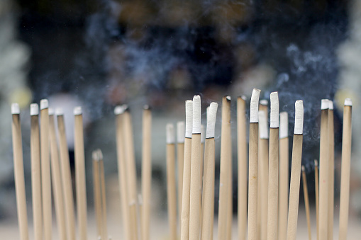 Burning incense sticks during Chinese prayers.