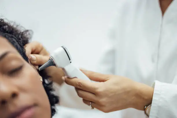 Otoscopic examination, close-up. Ear examination with otoscope, medical instrument.