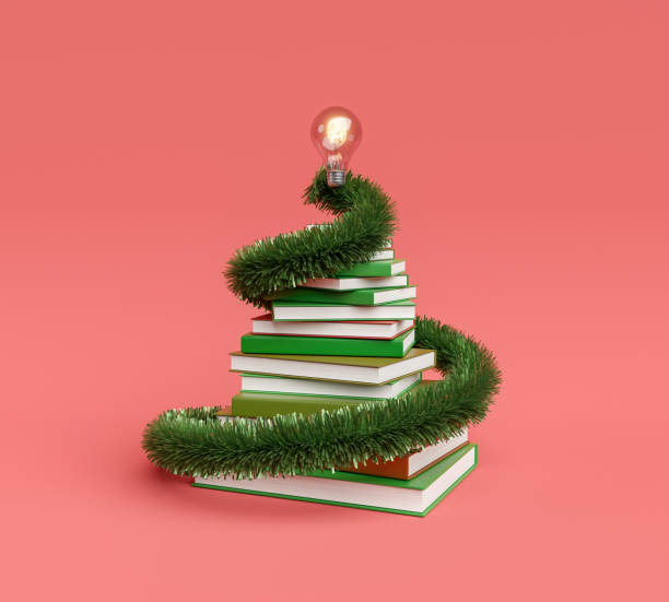 stack of books with christmas ornament and light bulb