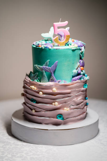 istock a large birthday cake in a nautical style with a candle number five. 1345160057
