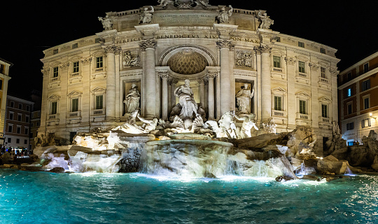 A panoramic image of Trevi Fountain in Rome Italy at night