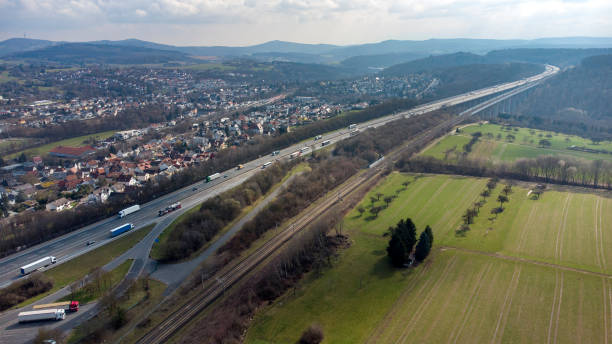 istock German highway and highspeed train railroad track - aerial view 1345165471