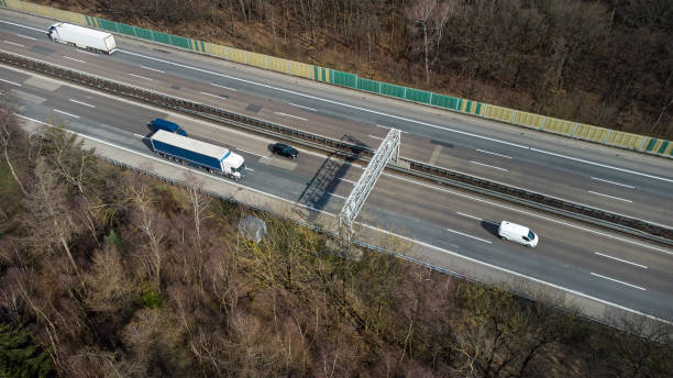 istock Truck toll system on highway - control gantry, aerial view 1345165489