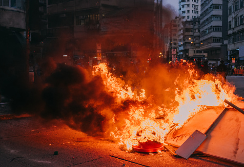 Burning street blockade in Hong Kong, China\nprotesters blocked roads