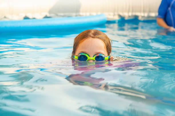 istock Girl In Back Yard Swimming Pool 1345165655