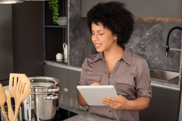 istock woman looking at tablet for recipe 1345166365