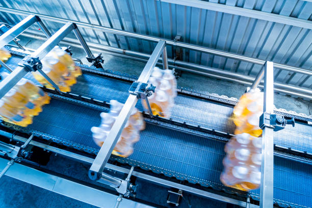 istock Modern strapping and transporting machine for packaging line at beverage plant. 1345166933