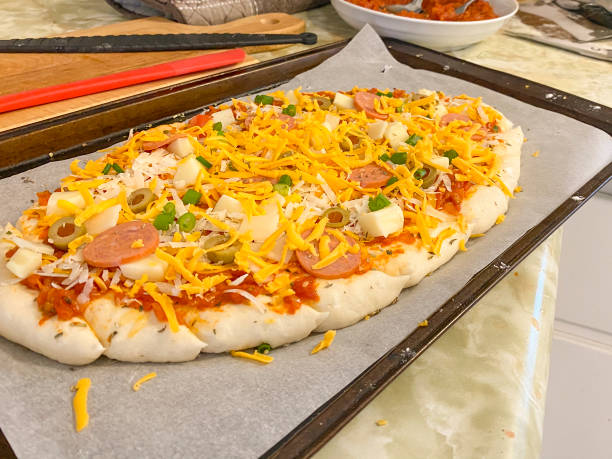 istock Homemade Pizza On Oval Shaped Dough 1345170755