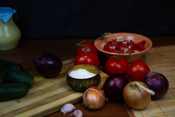 istock tomatoes, cucumbers and garlic on wooden longing. dark background 1345171676