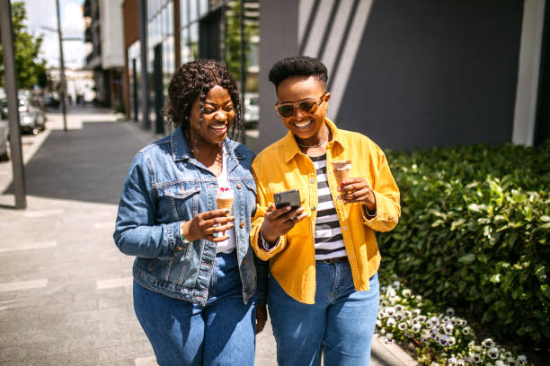 istock Using smartphone on the move in the city walk 1345171939