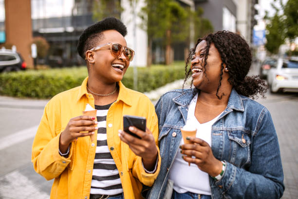 istock Two friends having fun in the city 1345172518