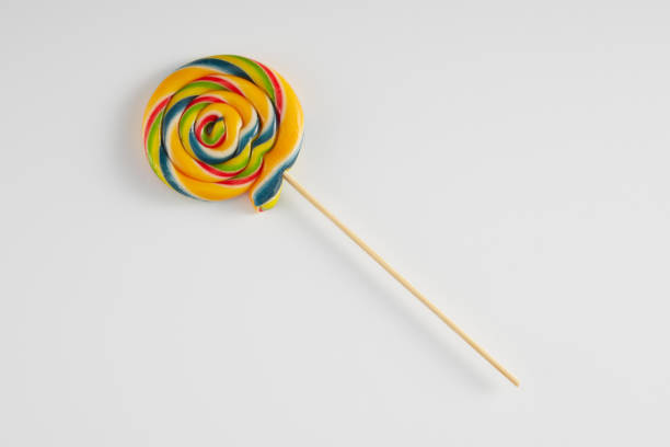istock Bright coloured lollipop against a white background. 1345173652