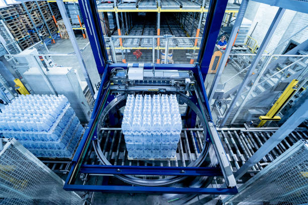 istock Modern strapping and transporting machine for packaging line at beverage plant. 1345173660