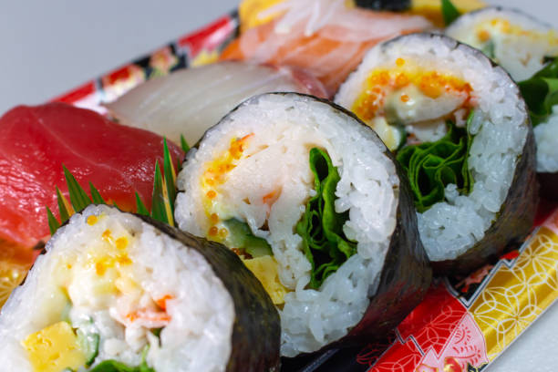 Closeup a pack of Makizushi and Nigiri Sushi sold by local supermarket in Japan Closeup a pack of Makizushi and Nigiri Sushi sold by local supermarket in Japan. Makizushi is a type of sushi where sushi rice and a variety of ingredients such as Tamagoyaki, Kanpyo, Fish etc salmon and red snapper stock pictures, royalty-free photos & images