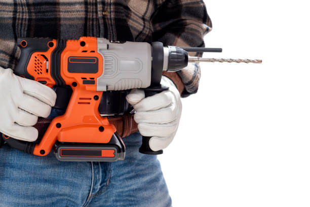 istock Carpenter holding rechargeable hammer drill, isolated on white background. 1345174001