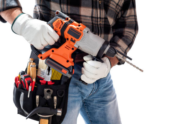 istock Carpenter holding rechargeable hammer drill, isolated on white background. 1345174010